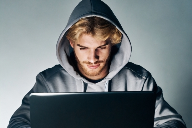 a white male coding on laptop